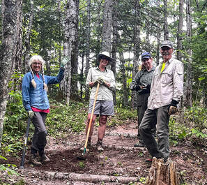 Crew of 4 volunteers working on trail improvements