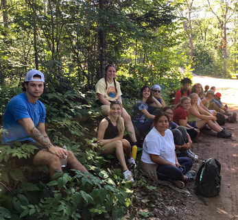 A group of Northland College students sitting on the side of the new trail.