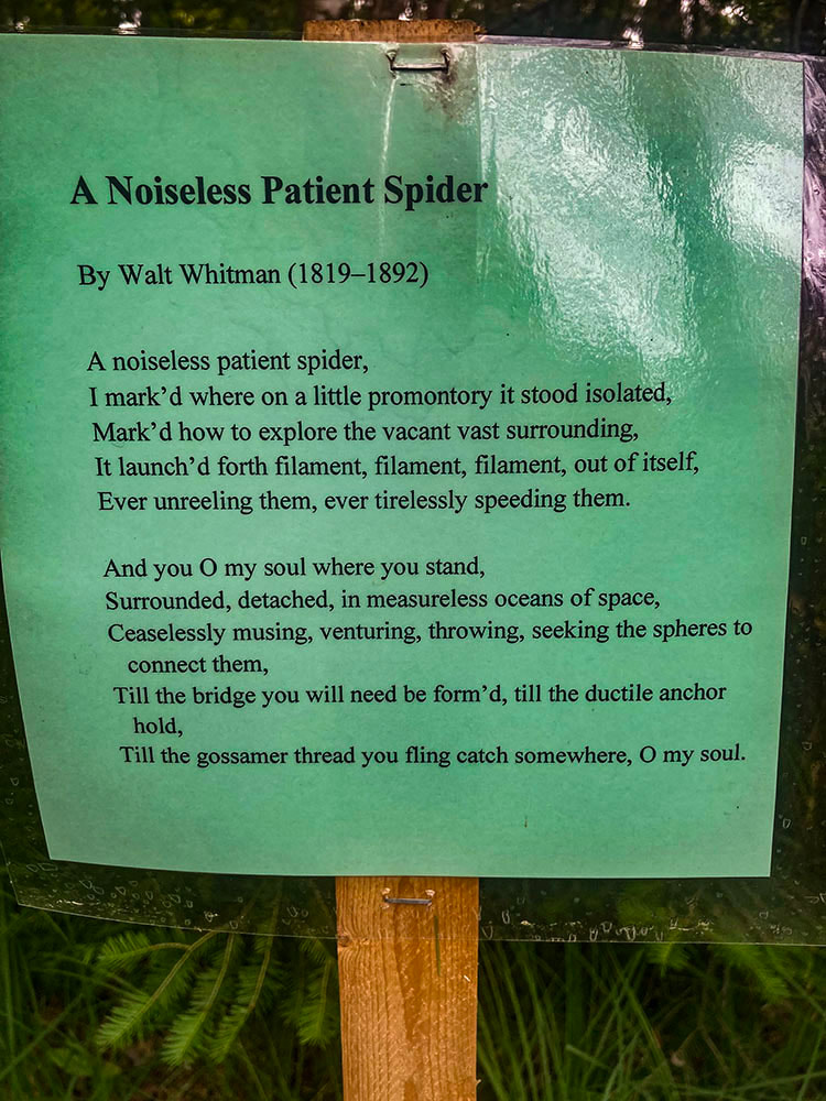 A sign displaying Walt Whitman's poem - 