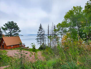 A-frame house perched above Lake Superior showing in the background.